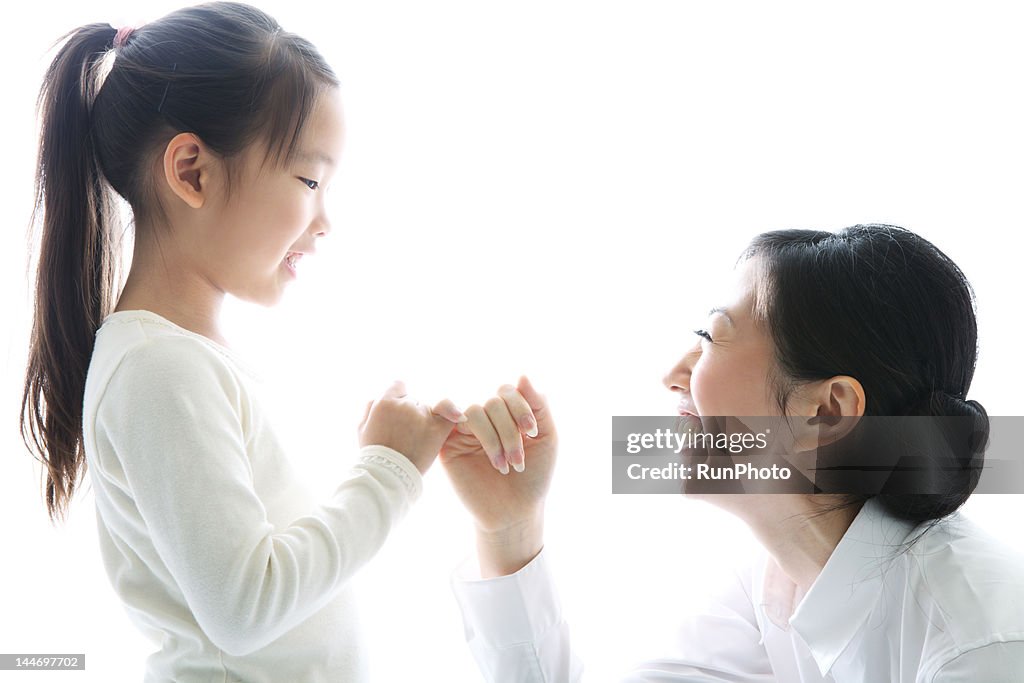 Mother and daughter pinky swearing