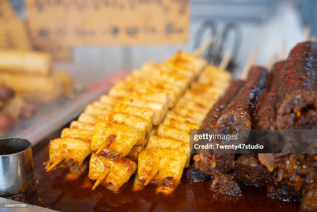 Closeup Korean fish cake skewers with chili sauce