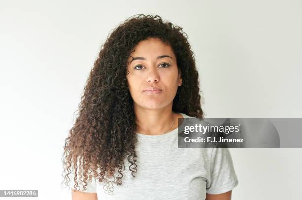 portrait of woman with curly hair on white background - no make up stockfoto's en -beelden