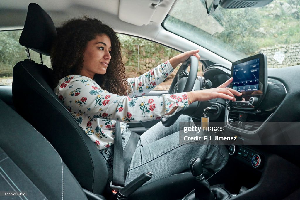 Woman using digital radio in car