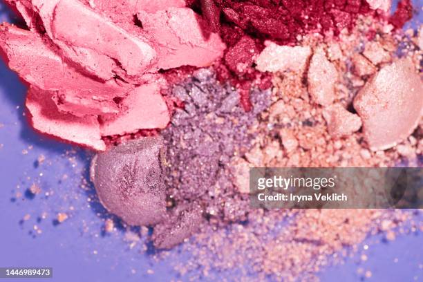 cosmetic make-up  product for a woman  - eyeshadow in powder in  pink and  red viva magenta  color of the year 2023 on pastel violet  color background. - blush makeup ストックフォトと画像