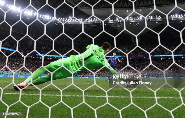 Dominik Livakovic of Croatia saves the fourth penalty by Maya Yoshida of Japan in the penalty shoot out during the FIFA World Cup Qatar 2022 Round of...