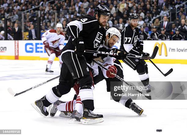 Willie Mitchell of the Los Angeles Kings defends Antoine Vermette of the Phoenix Coyotes in the first period in Game Three of the Western Conference...