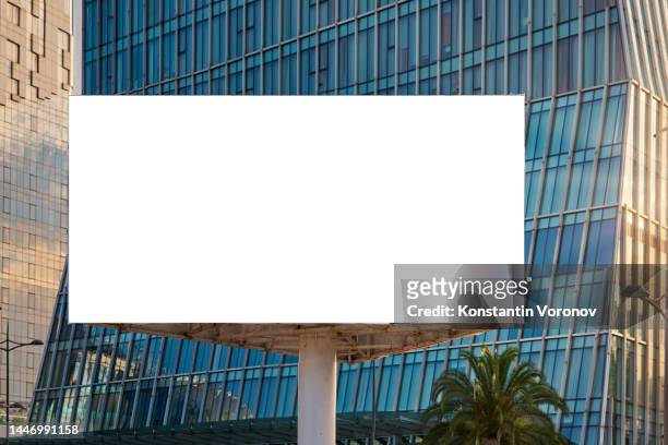 triangular billboard mockup. skyscrapers, business district on background. copy space on white screen. - exhibition center stock-fotos und bilder