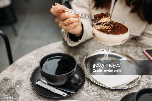 eating homemade tramisu with americano - grädde bildbanksfoton och bilder