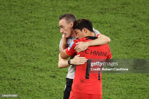 Paulo Bento, Head Coach of Korea Republic, embraces Heechan Hwang after the 1-4 loss during the FIFA World Cup Qatar 2022 Round of 16 match between...