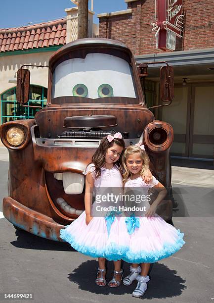 In this handout photo provided by Disney Parks, internet sensations Sophia Grace Brownlee and Rosie Grace McClelland tape a segment with Mater of the...