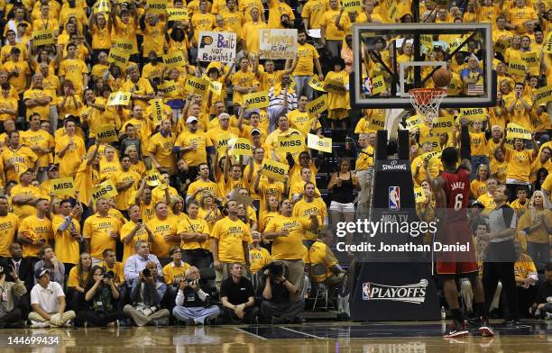 Fans try to distrack LeBron James of the Miami Heat as he shoots a free throw against the Indiana Pacers in Game Three of the Eastern Conference...