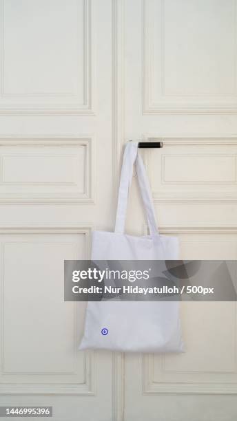 close-up of bag hanging on door,indonesia - tote bag stock pictures, royalty-free photos & images