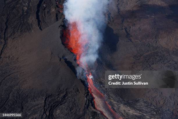In an aerial view, lava shoots up from a fissure of Mauna Loa Volcano as it erupts on December 05, 2022 in Hilo, Hawaii. For the first time in nearly...