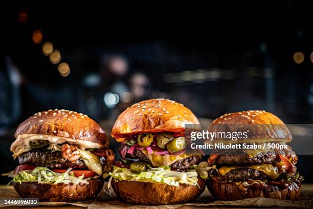 close-up of burgers on table - burger on grill imagens e fotografias de stock