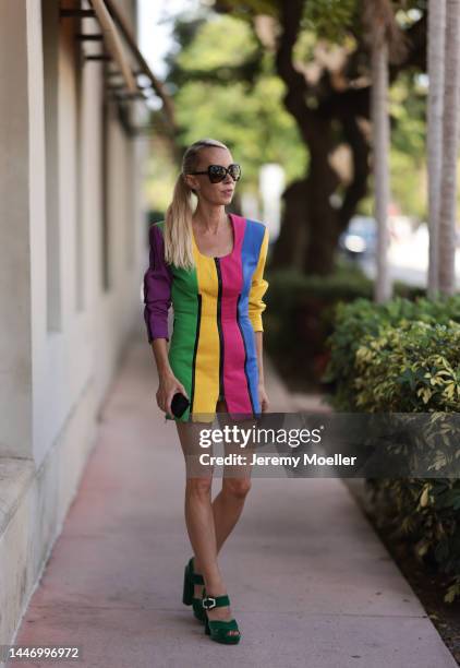 Denisa Palsha seen wearing a Vintage colourful striped mini dress, green velvet Prada heels and glasses by Tom Ford on December 03, 2022 in Miami,...