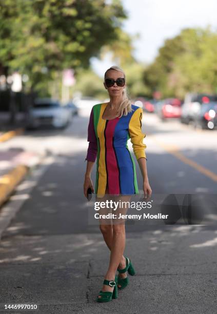 Denisa Palsha seen wearing a Vintage colourful striped mini dress, green velvet Prada heels and glasses by Tom Ford on December 03, 2022 in Miami,...