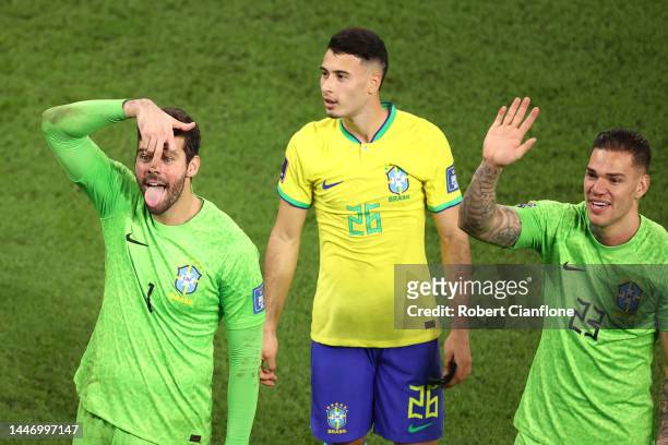 Alisson Becker, Gabriel Martinelli and Ederson of Brazil applaud fans after the 4-1 win during the FIFA World Cup Qatar 2022 Round of 16 match...