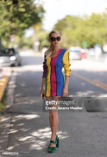 Denisa Palsha seen wearing a Vintage colourful striped mini dress, green velvet Prada heels and glasses by Tom Ford on December 03, 2022 in Miami,...