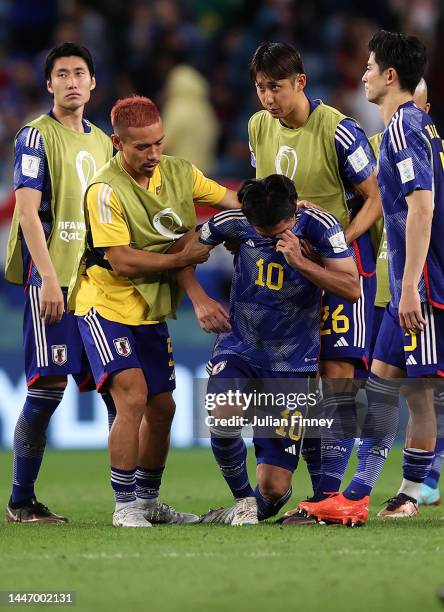 Takumi Minamino of Japan looks dejected after their teams exit from the World Cup during the FIFA World Cup Qatar 2022 Round of 16 match between...