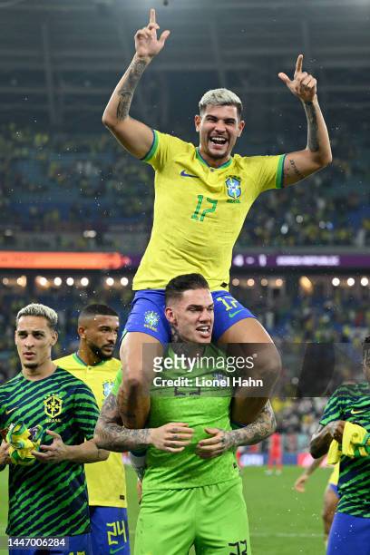 Bruno Guimaraes and Ederson of Brazil celebrate their victory during the FIFA World Cup Qatar 2022 Round of 16 match between Brazil and South Korea...