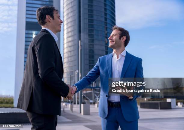 two office colleagues greeting by shaking hands before entering work, businessmen and ceos of companies outside of work - director office stock pictures, royalty-free photos & images