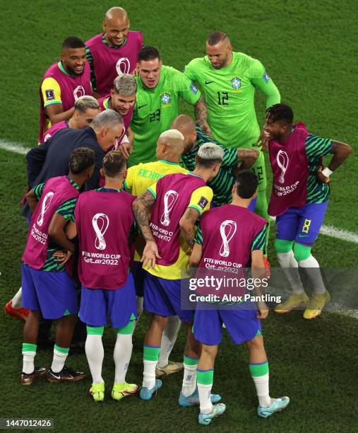Richarlison of Brazil celebrates with team mates and Adenor Leonardo Bacchi, Head Coach of Brazil, after scoring the sides third goal during the FIFA...