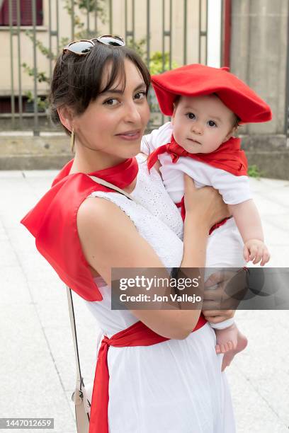 baby less than a year old in his mother's arms dressed in a typical holiday outfit - fiesta of san fermin stock pictures, royalty-free photos & images