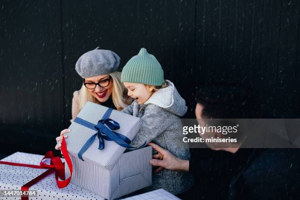 niña emocionada recibe un gran regalo de navidad al aire libre - open day 3 fotografías e imágenes de stock