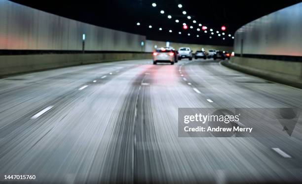 driving fast in road tunnel highway speed motion - driverless cars foto e immagini stock