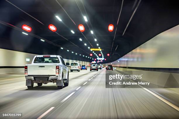 driving in tunnel, ute pickup truck, highway road - túnel de carretera fotografías e imágenes de stock