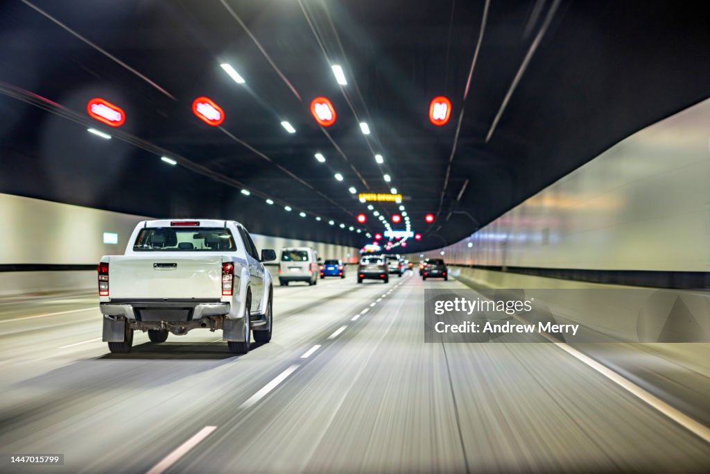 Driving in tunnel, ute pickup truck, highway road