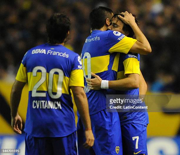 Juan Roman Riquelme hugs Pablo Mouche, author of the goal, while Dario Cvitanich walks to join them during a match as part of the Santander...