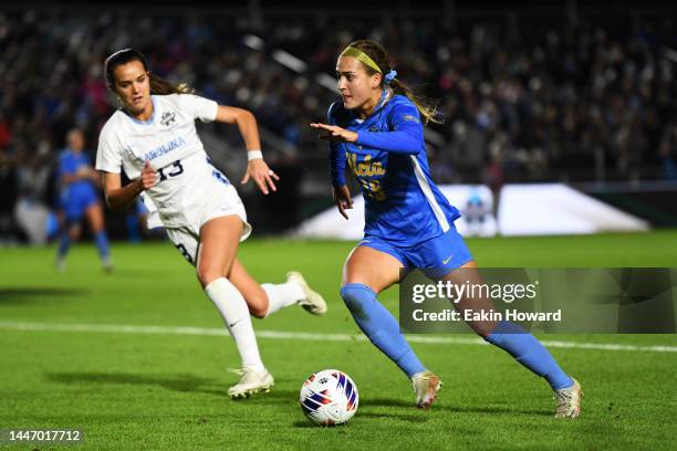 Quincy McMahon of the UCLA Bruins dribbles the ball against Isabel Cox of the North Carolina Tar Heels in the first half during the Division I...