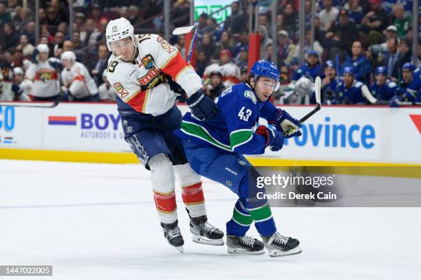 Quinn Hughes of the Vancouver Canucks defends against Matthew Tkachuk of the Florida Panthers during the first period of their NHL game at Rogers...