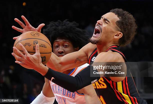 Trae Young of the Atlanta Hawks draws a foul as he drives against Jalen Williams of the Oklahoma City Thunder during the first half at State Farm...