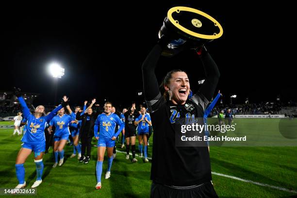 Goalkeeper Lauren Brzykcy of the UCLA Bruins holds the trophy after defeating the the North Carolina Tar Heels in overtime to win the Division I...
