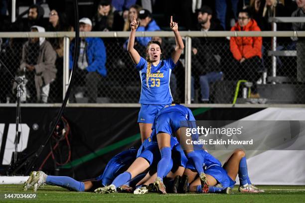 Ally Cook of the UCLA Bruins celebrates with her team after a second overtime period goal by Maricarmen Reyes during the Division I Women’s Soccer...