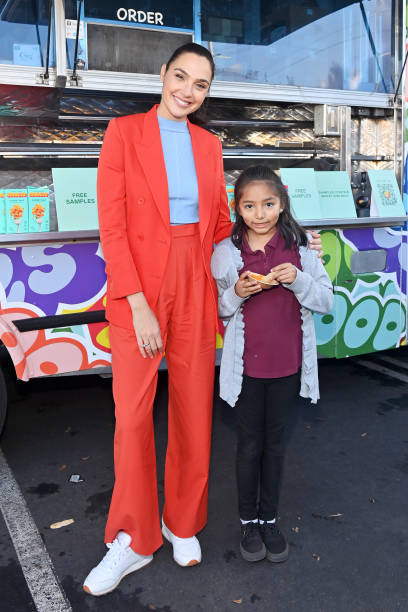 Gal Gadot poses with a guest during GOODLES' First Anniversary With Expansive Retail Launch Into Safeway Albertsons on December 05, 2022 in Los...