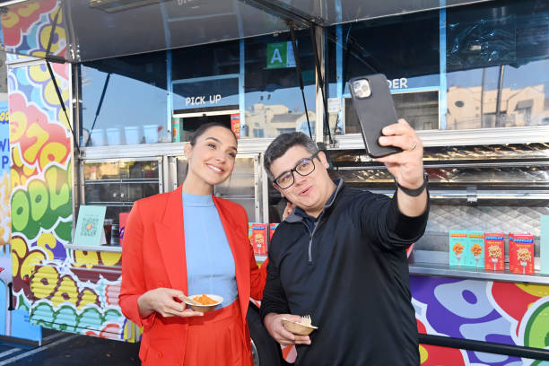 Gal Gadot and Joseph Escobar, Albertsons Companies National Category Director take a selfie during GOODLES' First Anniversary With Expansive Retail...