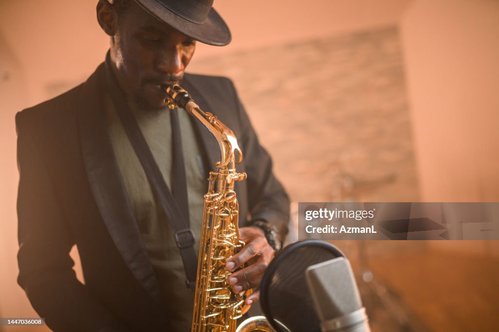 Black Mid-Adult Saxophonist Recording Music in Recording Studio