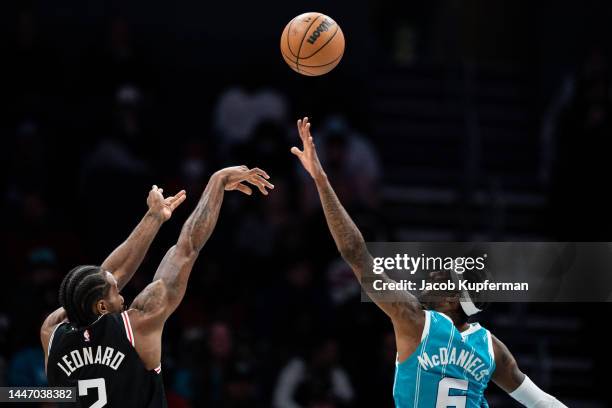 Kawhi Leonard of the LA Clippers shoots the ball while guarded by Jalen McDaniels of the Charlotte Hornets in the fourth quarter during their game at...