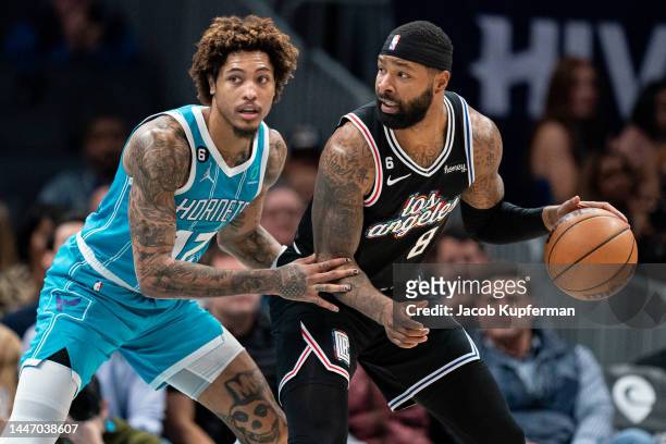 Kelly Oubre Jr. #12 of the Charlotte Hornets guards Marcus Morris Sr. #8 of the LA Clippers in the fourth quarter during their game at Spectrum...
