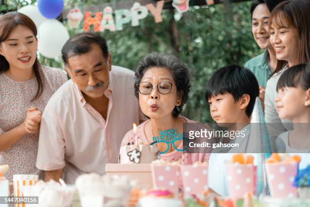 grandmother gets birthday celebration on a family gathering - south east asia people stock pictures, royalty-free photos & images