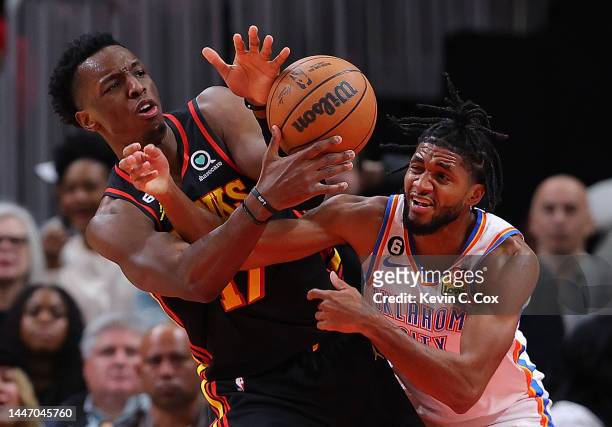 Onyeka Okongwu of the Atlanta Hawks and Isaiah Joe of the Oklahoma City Thunder battle for a rebound during the second half at State Farm Arena on...