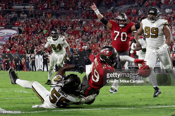 Rachaad White of the Tampa Bay Buccaneers scores a touchdown against Demario Davis of the New Orleans Saints late in the fourth quarter during the...