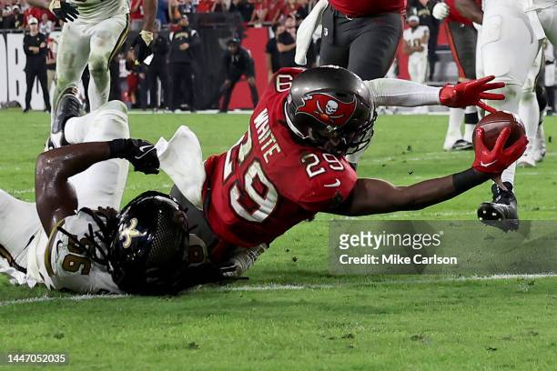 Rachaad White of the Tampa Bay Buccaneers scores a touchdown against Demario Davis of the New Orleans Saints late in the fourth quarter during the...