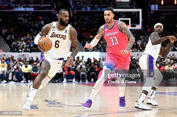 LeBron James of the Los Angeles Lakers handles the ball against Kyle Kuzma of the Washington Wizards at Capital One Arena on December 04, 2022 in...