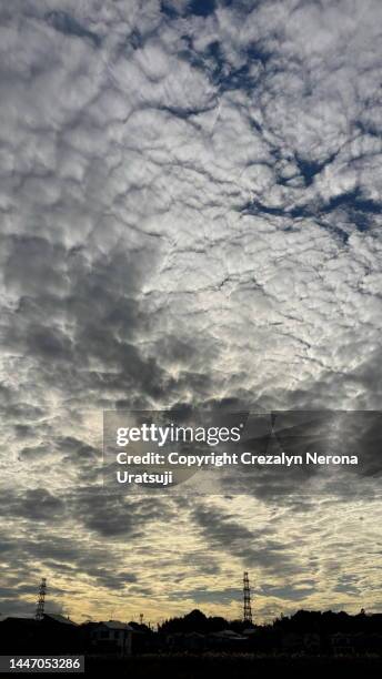 non urban scene with steel towers and beautiful clouds - tetto stock-fotos und bilder