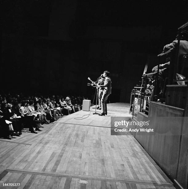 John Lennon performing on stage with The Beatles, at Fairfield Halls, Croydon, 25th April 1963. The Beatles played two shows at the venue that day as...