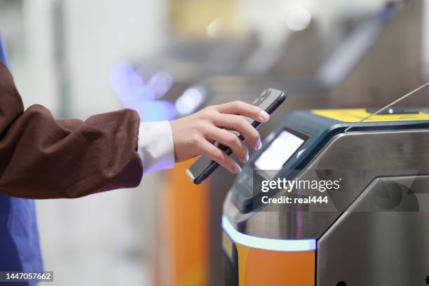 boy using phone on scanner by entrance to city transport - sinal de entrada imagens e fotografias de stock