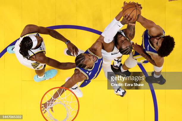 Oshae Brissett and Isaiah Jackson of the Indiana Pacers go for a rebound against Moses Moody and Anthony Lamb of the Golden State Warriors at Chase...