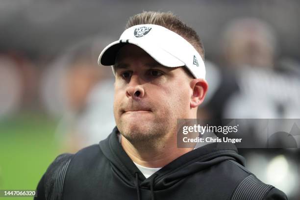 Head coach Josh McDaniels of the Las Vegas Raiders walks off the field after warmups before a game against the Los Angeles Chargers at Allegiant...