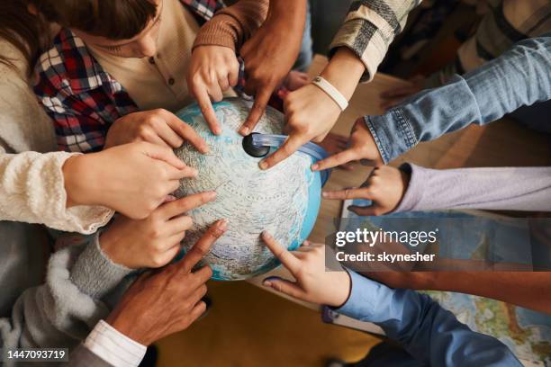 the globe is big enough for everyone! - teacher pointing finger stock pictures, royalty-free photos & images